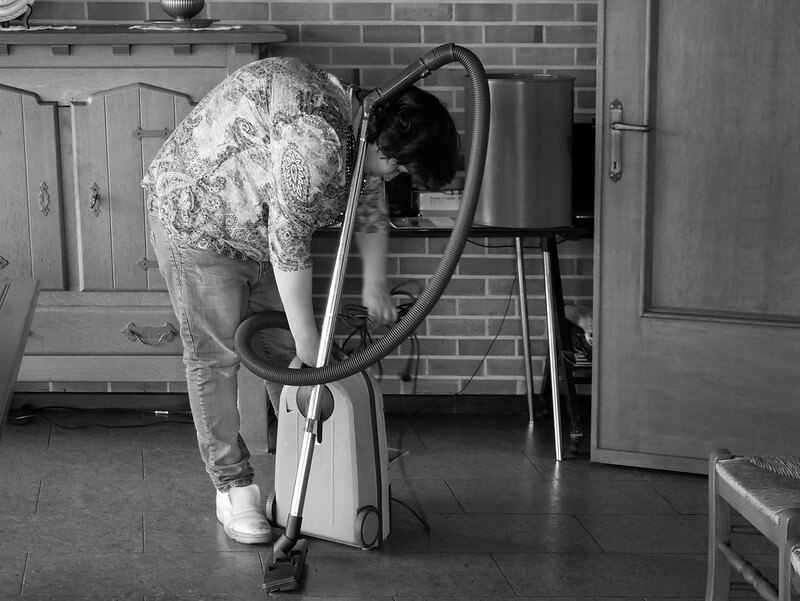 Maid About to Clean the House with a Vacuum Cleaner